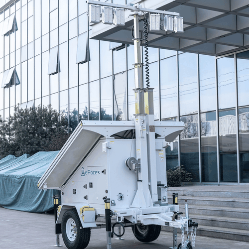 Trailer-mounted mobile light tower with its telescopic mast raised and outriggers down