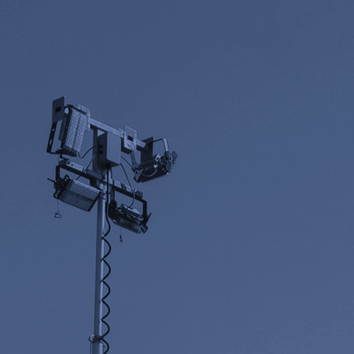 Trailer-mounted light tower parked on open ground with the mast extended